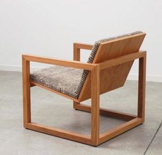 a wooden chair sitting on top of a cement floor