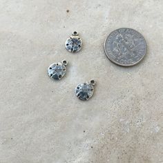 These are adorable and small sand dollar charms! The perfect finish for a nautical themed piece. They are small, cute and delicate. Sterling silver and one sided 10x7mm ~ 3 charms Orders ship out within 24 hours. Find more beads at http://www.marketplacebeads.etsy.com Please feel free to contact us with any questions. Use coupon code CREATE22 to receive 10% off orders over $100.00 THIS ITEM WILL BE SHIPPED OUT WITHIN 24 HOURS OF ORDERING FREE SHIPPING WITHIN THE UNITED STATES Sand Dollar, Nautical Theme, Coupon Codes, Stud Earrings, Beads, Sterling Silver, 10 Things, Silver