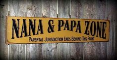 a sign that says nanna & papa zone on it's side against a wooden fence