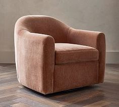 a brown chair sitting on top of a wooden floor next to a wall and window