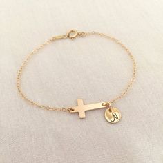 Personalized Rose Gold Filled Cross Bracelet, Sideways Cross, Gold Fill Baptism Bracelet, Baby Girl Christening, Baby Boy, Simple CrossAvailable in Sterling Silver, 14K Gold Filled and 14K Rose Gold Filled.Please be sure to leave initial in the note box at checkout.Specification. Cross size 9.4 x 17mm. Disc size 7mm. Comes in a satin pouch. Length includes charm, jump ring and claspCross Bracelet in Sterling Silver available here:http://etsy.me/2s2xpxQIMPORTANT:Usually jewellery in the pictures Baptism Bracelet, Cross Gold, Satin Pouch, Simple Cross, Girl Christening, Note Box, Hand Stamped Jewelry, Cross Bracelet