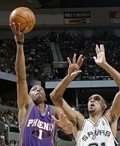 two basketball players trying to block the ball