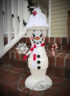 a snowman on the steps with a hat and scarf