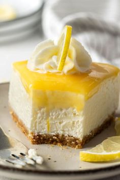 a piece of cheesecake on a plate with lemon wedges