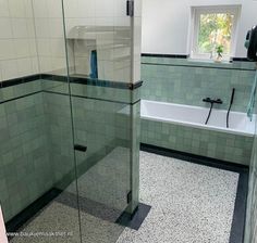 a bath room with a tub a sink and a mirror