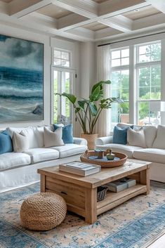 a living room filled with furniture and a painting hanging on the wall above it's windows