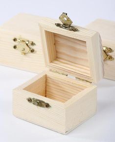 two wooden boxes sitting on top of a white table next to each other with handles