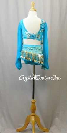 Turquoise custom made 2 piece long sleeve top and asymmetrical skirt. Base of the costume is Turquoise lycra top and trunk with Lt Teal Blue floral lace, Teal Blue sheer mesh sleeves, neckline and skirt. Accented with Lt Teal Blue embroidered flower appliques, Gold dangling beaded/coin trim and Swarovski rhinestones! **Accessories Include: Headpiece Almost 6 gross Blue Zircon Shimmer 30ss, Blue Zircon Shimmer 20ss, Blue Zircon Shimmer 16ss, Blue Zircon Shimmer 1ss, Lt Turquoise AB 30ss, Lt Turquoise AB 20ss, Lt Turquoise AB 16ss, Lt Turquoise AB 12ss, Lt Colorado Topaz 30ss, Lt Colorado Topaz 20ss, and Lt Colorado Topaz 16ss rhinestones!! Blue Fitted Set For Costume Party, Fitted Blue Sets For Costume Party, Fitted Blue Set For Costume Party, Blue Fitted Sequin Skirt, Fitted Blue Sequin Skirt, Turquoise Fitted Long Sleeve Sets, Fitted Belly Dance Sets For Party, Long Sleeve Top And Skirt, Baggy Clothing