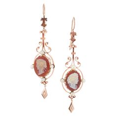 Pendant dangle style 1900’s 15k rose gold carved hardstone cameo dangle earrings with natural pearl accents, one or two may have been replaced with cultured pearls. 2 crème orange brown hardstone cameos 8 gray crème pearls, 3.4mm 15k rose gold 15k yellow gold Tested: 15k 14.7 grams Top to bottom: 65mm or 2.5 Inches Width: 19.9mm or .75 Inch Depth or thickness: 20.0mm Victorian Wedding Ring, Rose Gold Dangle Earrings, Antique Wedding Bands, Diamond Sapphire Engagement Ring, Antique Engagement Rings Vintage, Antique Bracelets, Vintage Sapphire, Color Crema, Gold Dangle Earrings