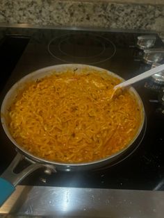 a pan filled with food sitting on top of a stove