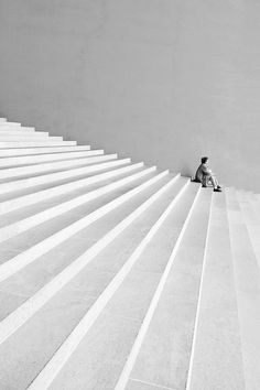 a man sitting on top of a set of stairs