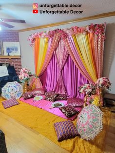 an elaborate bed with pink and yellow drapes