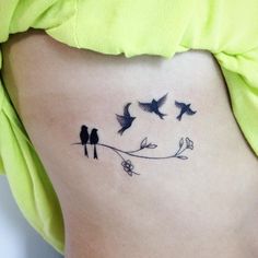 a woman's stomach with birds on it