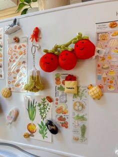 a refrigerator with magnets on the door and pictures hanging from it's side