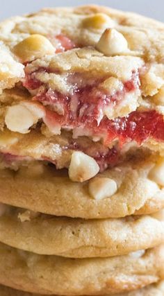 a stack of cookies with jelly and almonds on top, all stacked up together