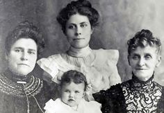 an old photo of three women and a baby