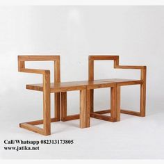 two wooden benches sitting next to each other on a white surface with no one around them