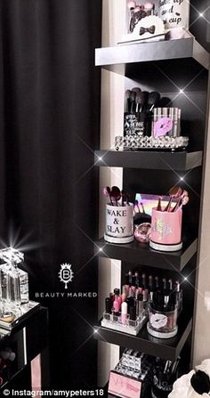 a black and white bathroom with lots of beauty products on the shelve shelves