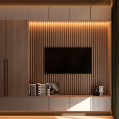 an entertainment center with a television mounted on the wall and wooden paneling behind it