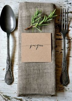 a place setting with silverware and an empty note on it that says i love you