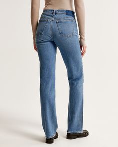 Our classic 90's-style jeans in a medium wash, with knee slash detail and a distressed hem. This fit features a 9.5” mid rise, is fitted at the waist and hips, and eases at the thigh into a straight, full-length leg shape. This jean is made from our vintage stretch fabric which features both an authentic vintage look and contains slight built-in stretch for additional comfort. 90s Style Jeans, Denim Collection, Style Jeans, Modern Wardrobe, Edgy Look, Pocket Bag, Chic Woman, Vintage Look, 90s Fashion