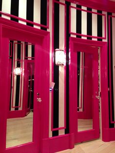 pink and black striped walls with mirrored doors