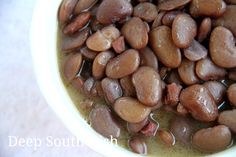 a white bowl filled with beans on top of a table