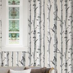 a living room with wallpaper that looks like birch trees