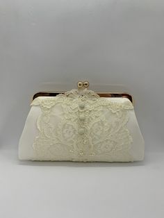 a white purse with lace on it