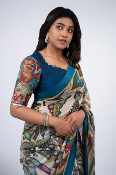 Peacock blue blouse with tribal floral kalamkari hand painted motifs and pitta, sequin work on border. - Aza Fashions Kalamkari Saree Blouse Design, Luxury Slub Silk Traditional Wear With Kalamkari Print, Kalamkari Saree Blouses, Kalamkari Saree Blouse Designs, Peacock Blue Blouse, Kalamkari Blouses, Kalamkari Blouse Designs, Gown Dress Party Wear, Patch Blouse