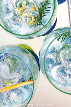 three glasses filled with ice and lemon slices