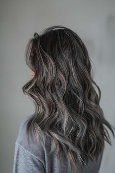 Save this pin for a stunning long wavy brunette with ash grey highlights! Feeling bored with your current hair color? Tap to see how these gorgeous highlights can add depth and dimension to your look, making you feel fabulous! Grey Hair Color Ideas For Brunettes, Dark Brunette Balayage Hair Ashy, Grey Brown Hair Balayage, Brunette Grey Hair, Adding Dimension To Dark Brown Hair, Ash Hair Color Grey, Icy Babylights, Dark Hair Ash Highlights