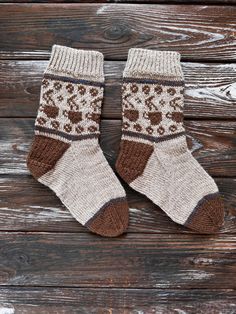 a pair of brown and white socks sitting on top of a wooden floor