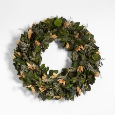 a wreath with green leaves and white flowers