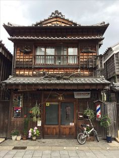 an old wooden building with a bicycle parked in front