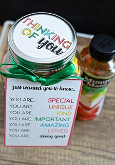 a jar filled with food sitting on top of a wooden table next to a sign