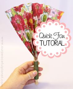 a person holding up some paper flowers with the words quick fun tutor written above it