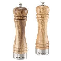 two salt and pepper shakers made out of wood, one with a metal top