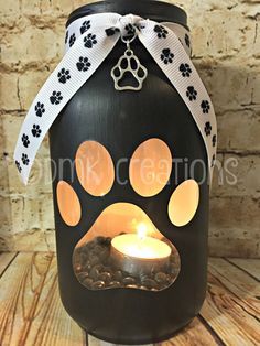 a dog paw lantern with a lit candle in it