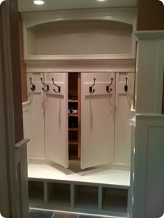 a room with some white cupboards in it