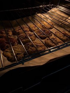 cookies baking in an oven on top of parchment paper and cooling rack with light coming through