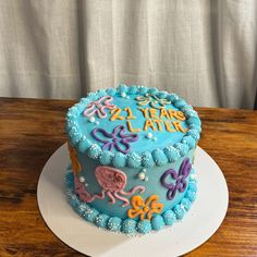 a birthday cake with blue frosting and colorful decorations