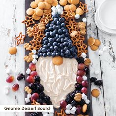 a platter filled with fruit and pretzels on top of a wooden table