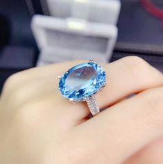 Welcome to Elegant Art Jewelry!  Stone: Natural Blue Topaz Stone Size:. 13mmx18mm Stone Cut:. Oval Cut Side Stone: Zirconia Metal: 925 Sterling Silver Personalization: 9K/14K/24K/GOLD/SILVER/PLATINUM/ROSE-GOLD/WHITE GOLD. (Contact me)  Topaz Ring, Topaz Cuff Ring, 925 Sterling Silver Ring, Round Shape Ring, Topaz Ring, Topaz Engagement, Open Design Ring, Topaz Round, Topaz Natural, Blue Topaz, Blue Gemstone, Gemstone Ring, Engagement Ring, Wedding Ring, Statement Ring, Topaz Ring, Victorian Ring Topaz Birthstone Ring, American Diamond Jewellery, Birthday Gift Ring, Victorian Ring, Wedding Plan, Topaz Engagement Ring, Cuff Ring, Topaz Jewelry, Jewelry Stone