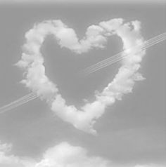 an airplane flying in the shape of a heart