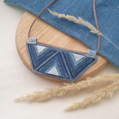 a wooden board with some blue jeans on it and a piece of fabric hanging from the back