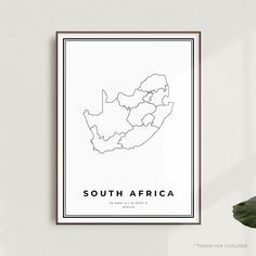 a black and white map of south africa on a wall next to a potted plant