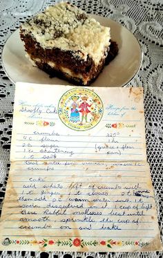 a piece of cake sitting on top of a white plate next to a handwritten recipe