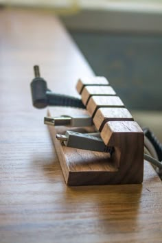 a close up of a wooden device on a table with wires attached to the back