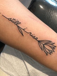 a person with a tattoo on their arm that says faith and an arrow in cursive writing